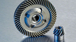 Spare Parts Catalogue Gear and small gear made of metal on a silver background.