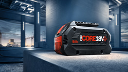 A Bosch Professional CORE 18V battery is placed on a gray surface.