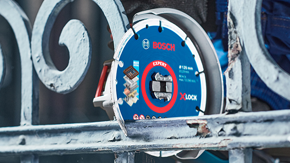 A Bosch Professional X-LOCK cutting disc hangs on a metal grid.