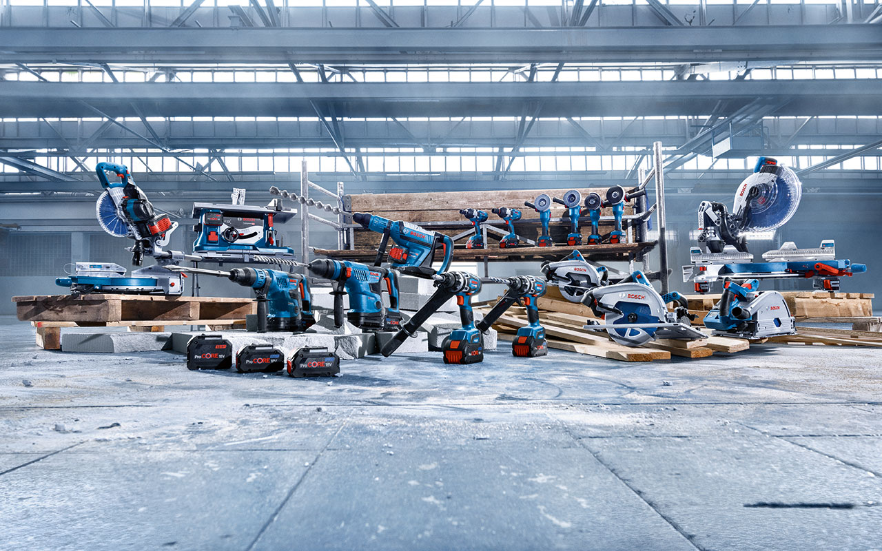 Various Bosch Professional tools on wooden pallets in a hall.