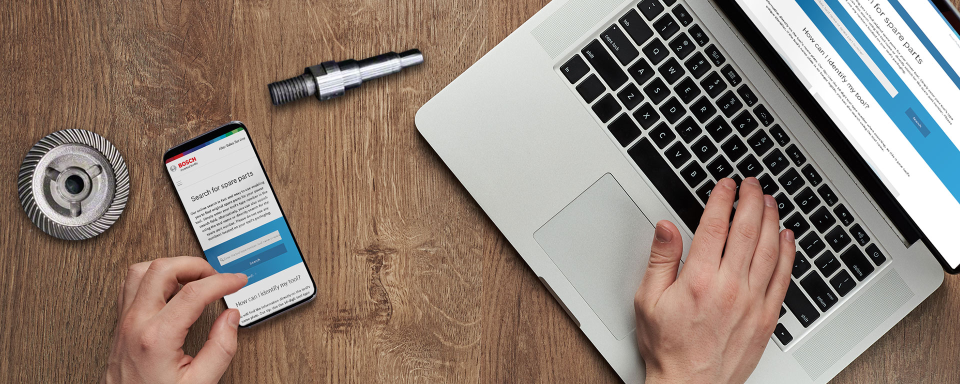 A hand operates a laptop and a smartphone with the Bosch website.